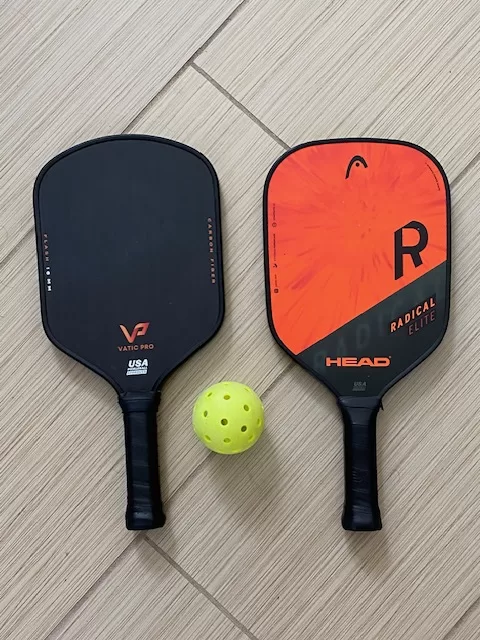 2 paddles and a pickleball 