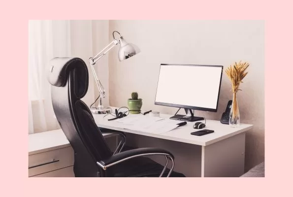 Home Office set-up for remote work with ergonomic chair, monitor, desk and lamp