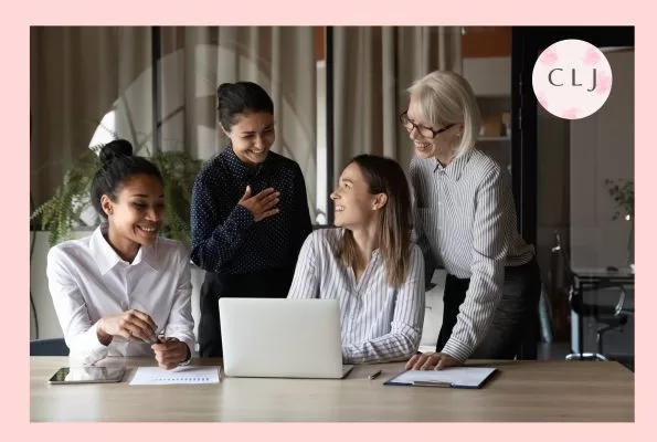 How to thank coworkers - a group of colleagues smiling at each other around a laptop