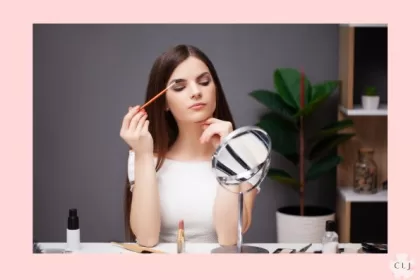 Girl applying makeup when working from home.