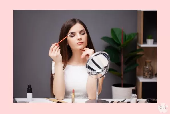Girl applying makeup when working from home.