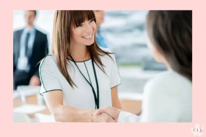 Two women at a networking even shaking hands while gaining professional development
