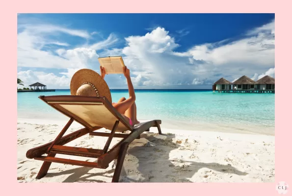 woman reading a book on a tropical island