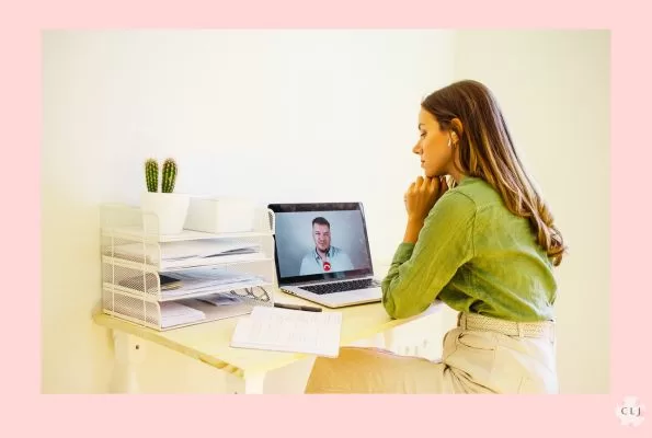 Woman in a business shirt and pants taking an online teleconference meeting with the boss