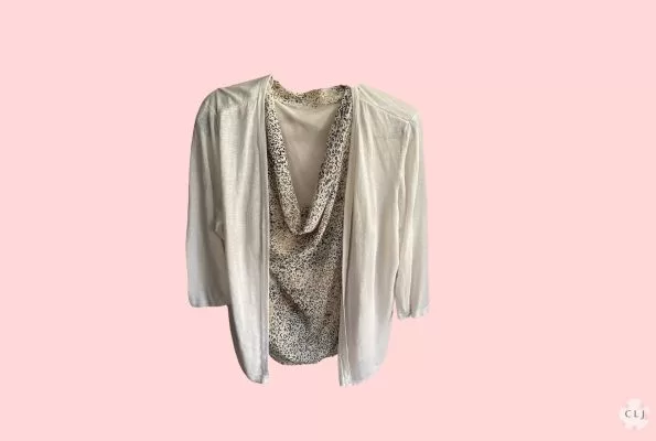 a white cardigan with a printed cowl neck shell